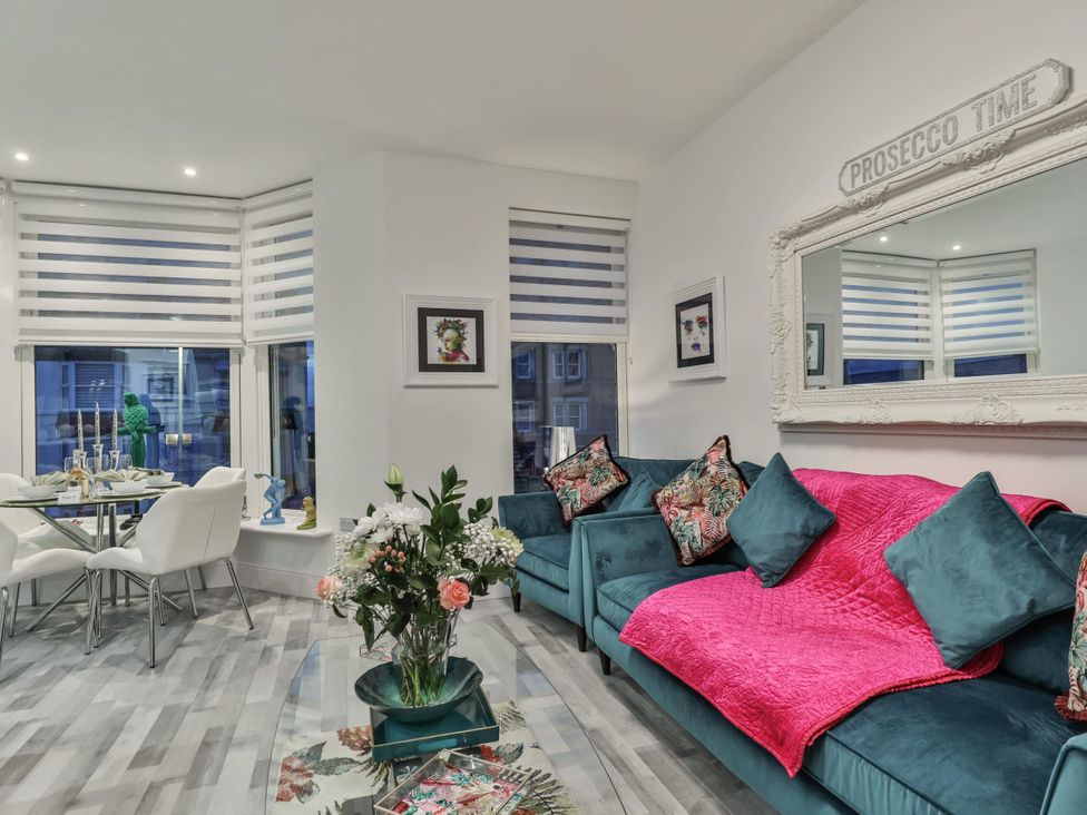 A living room with a sofa and dining area at 1 Bed Flat - Sleeps 2 - Parking - Wifi in Scarborough