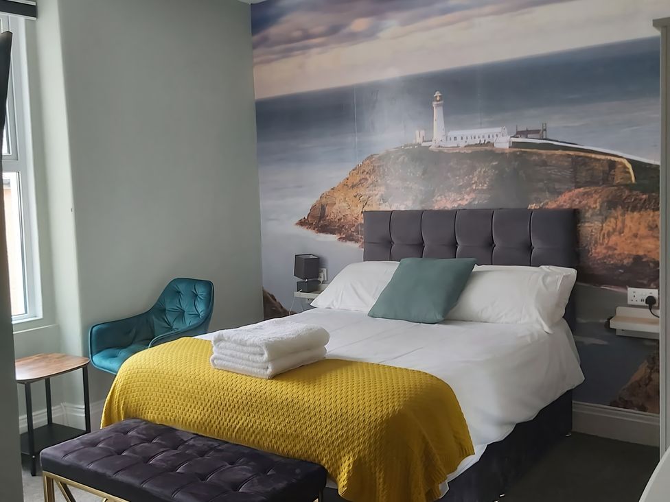A bedroom with a bed and wall mural at Holiday home guest house in Llandudno
