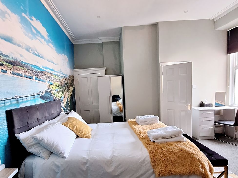A bedroom with a bed and desk at Holiday home guest house Llandudno