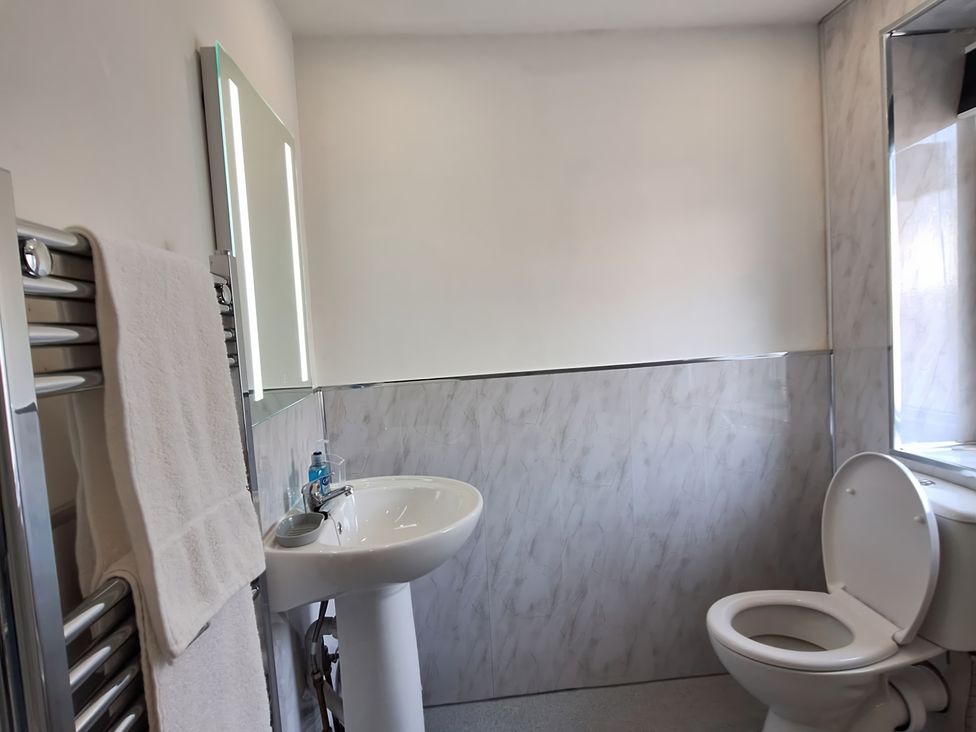 A bathroom with a sink and toilet at Holiday home guest house in Llandudno