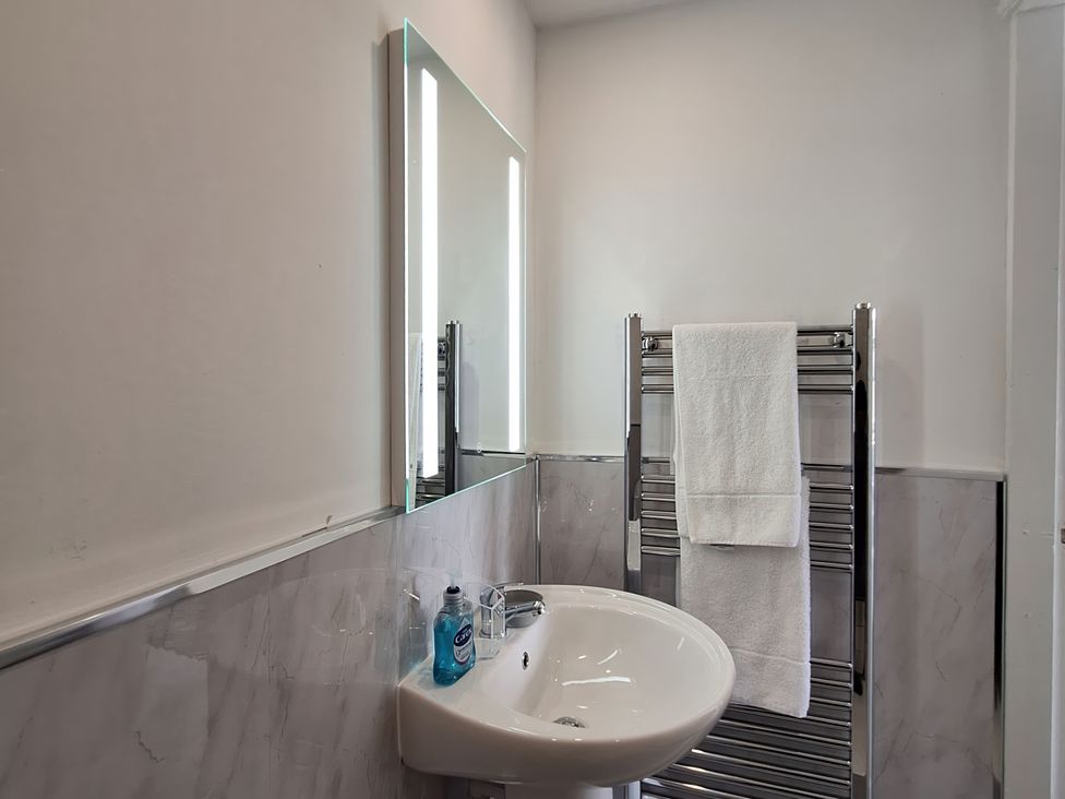 A bathroom with a sink and mirror at Holiday home guest house Llandudno