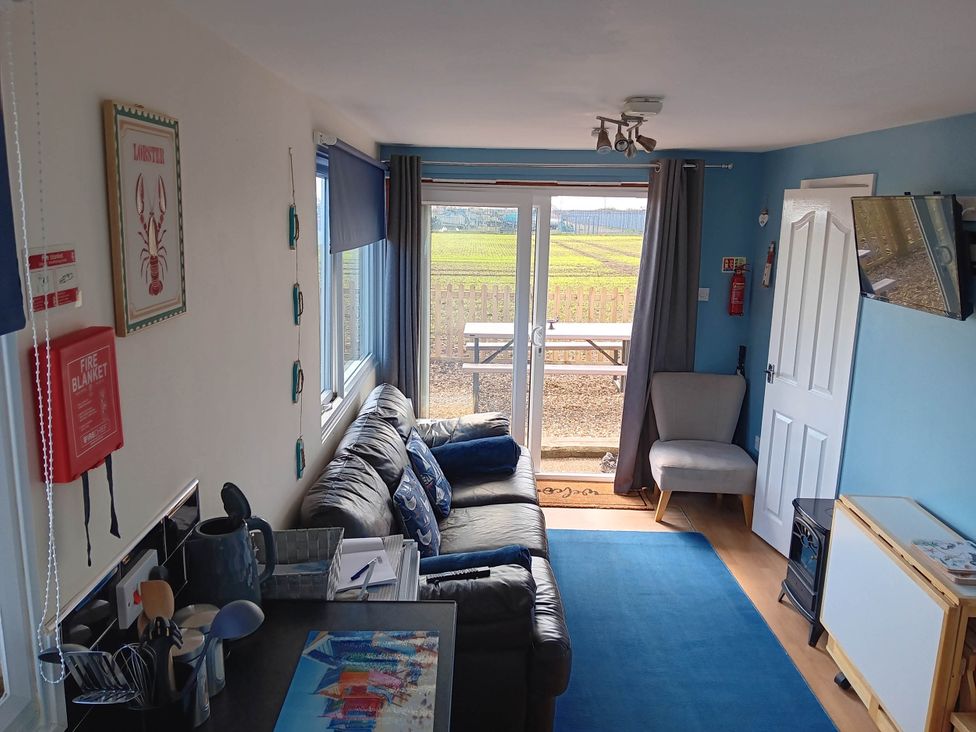 A living room with a sofa and table at Bay View Chalet 2 Bed Sleeps 4 Pets Garden Beach Wilsthorpe near Bridlington