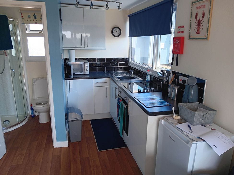 A kitchen with a sink and microwave at Bay View Chalet 2 Bed Sleeps 4 Pets Garden Beach Wilsthorpe near Bridlington