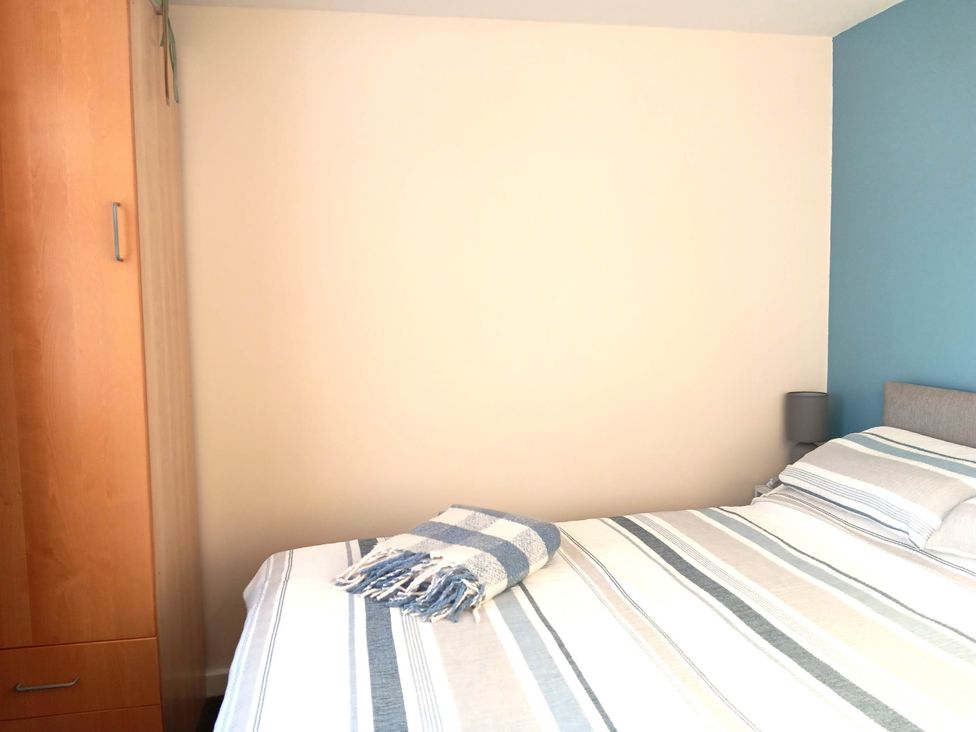 A bedroom with a bed and wardrobe at Bay View Chalet 2 Bed Sleeps 4 Pets Garden Beach Wilsthorpe near Bridlington