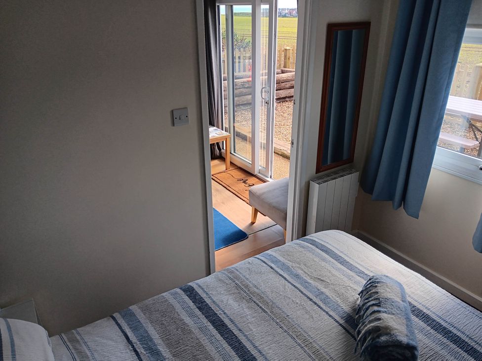 A bedroom with a bed and mirror at Bay View Chalet 2 Bed Sleeps 4 Pets Garden Beach Wilsthorpe near Bridlington