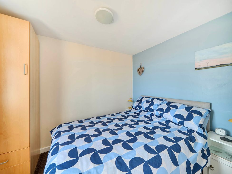 A bedroom with a bed and wardrobe at Bay View Chalet 2 Bed Sleeps 4 Pets Garden Beach Wilsthorpe near Bridlington