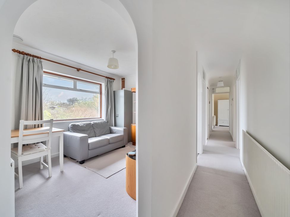 A living room with a sofa and dining table at Sleeps 9 KingBeds Family Friendly in Pityme near Penmayne