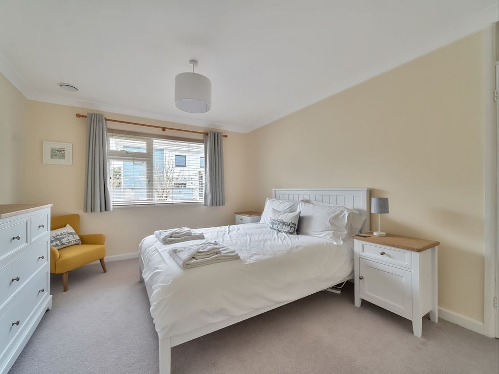 A bedroom with a bed and dresser at Sleeps 9 KingBeds Family Friendly in Pityme near Penmayne
