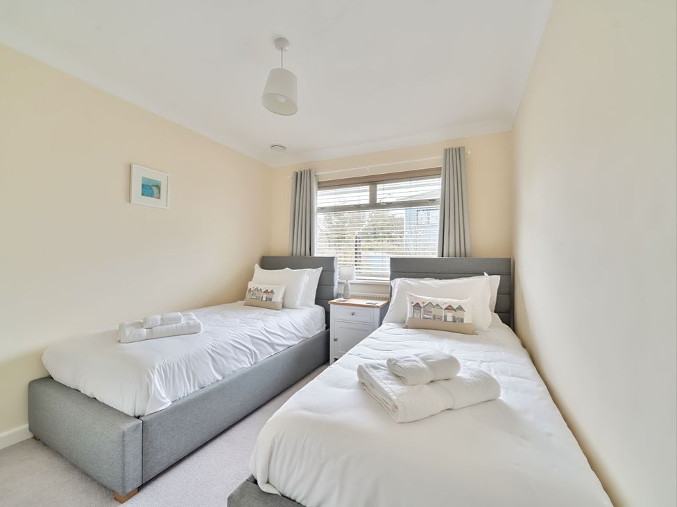 A bedroom with two single beds at Sleeps 9 KingBeds Family Friendly in Pityme near Penmayne