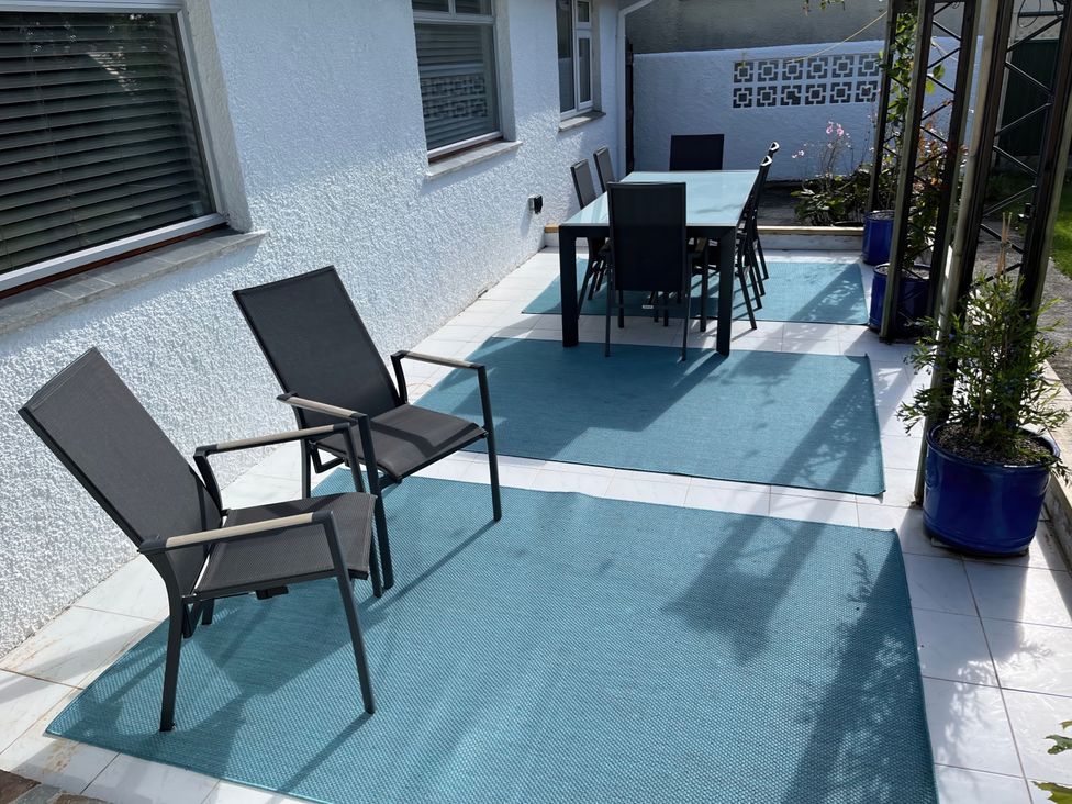 An outdoor space with chairs and a table at Sleeps 9 KingBeds Family Friendly Pityme near Penmayne