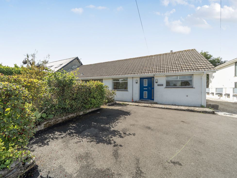A house with a blue door and driveway at Sleeps 9 KingBeds Family Friendly, Pityme near Penmayne