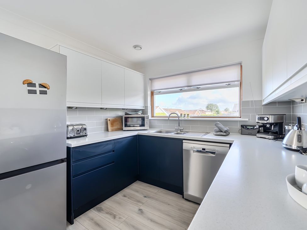 A kitchen with appliances and sink at Sleeps 9 KingBeds Family Friendly, Pityme near Penmayne