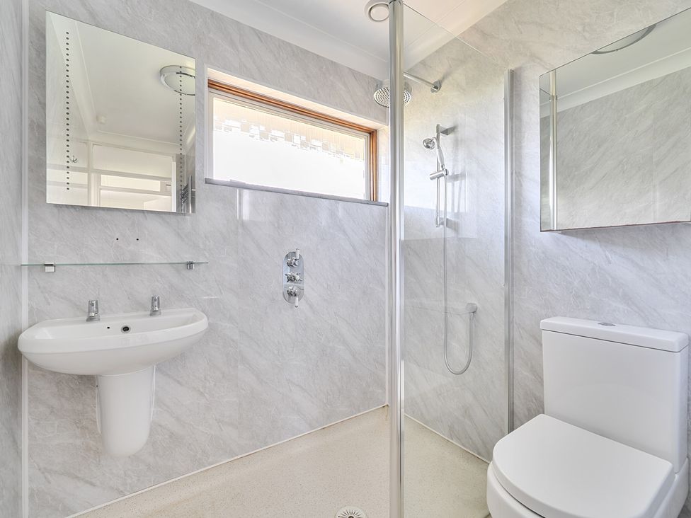 A bathroom with a sink, shower, and toilet at Sleeps 9 KingBeds Family Friendly in Pityme near Penmayne