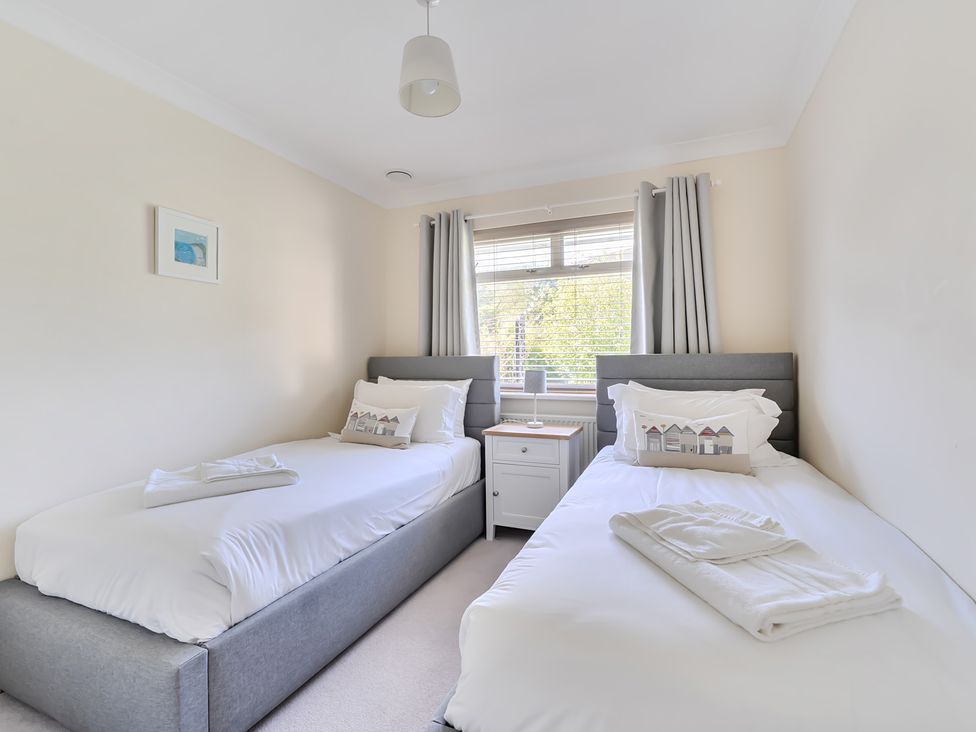 A bedroom with two beds and a window at Sleeps 9 KingBeds Family Friendly, Pityme near Penmayne