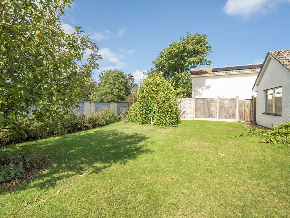 A garden with trees and a shed at Sleeps 9 KingBeds Family Friendly in Pityme near Penmayne