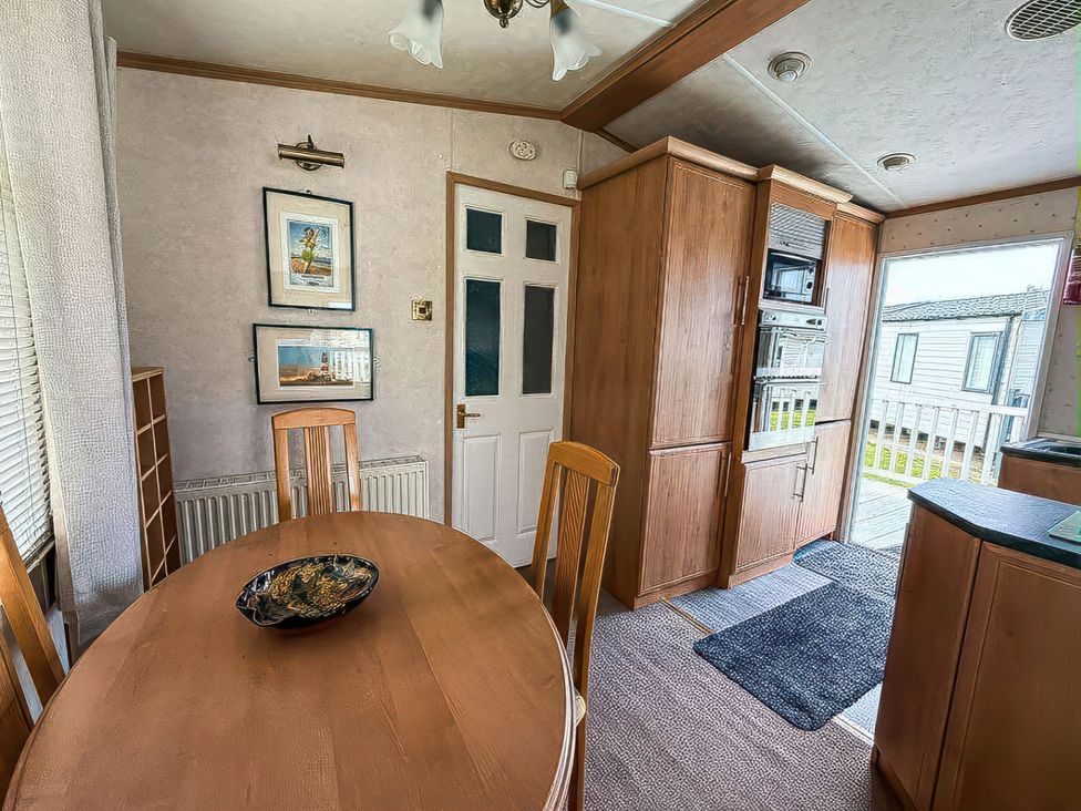 A dining room with a table and chairs at Super 2 bed 6 berth caravan pets go free Hunstanton