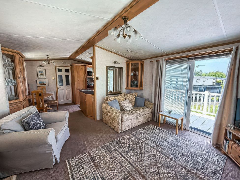 A living room with a sofa and dining table at Super 2 bed 6 berth caravan pets go free, Hunstanton