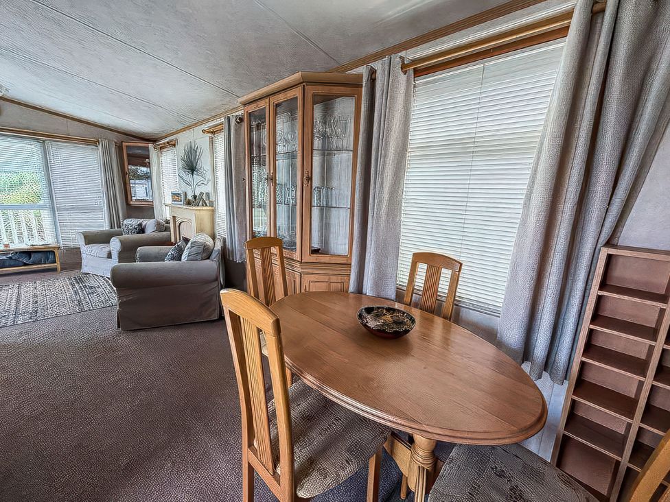 A living room with a dining table and chairs at Super 2 bed 6 berth caravan pets go free Hunstanton