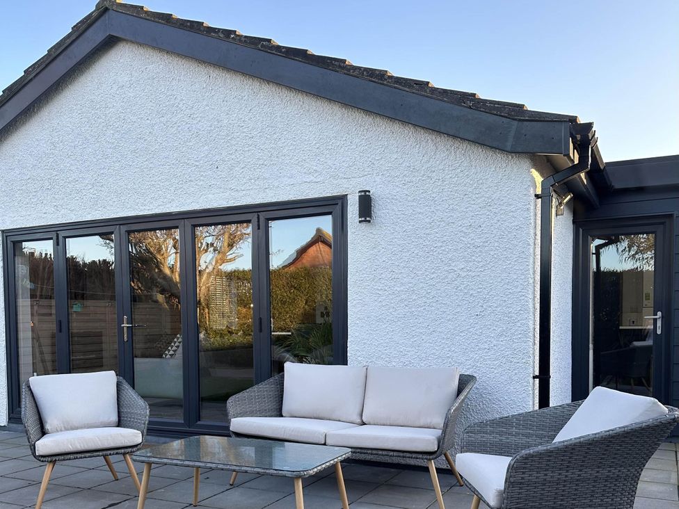 A patio with seating and a table at The Old Barn in Manchester