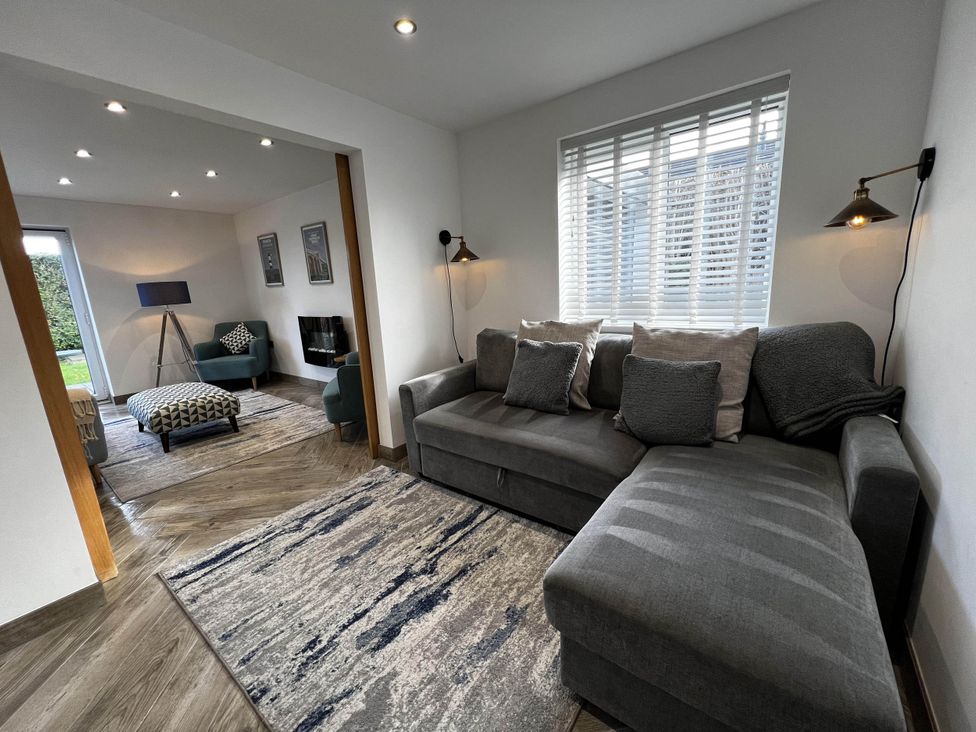 A living room with a sofa and rug at The Old Barn in Manchester