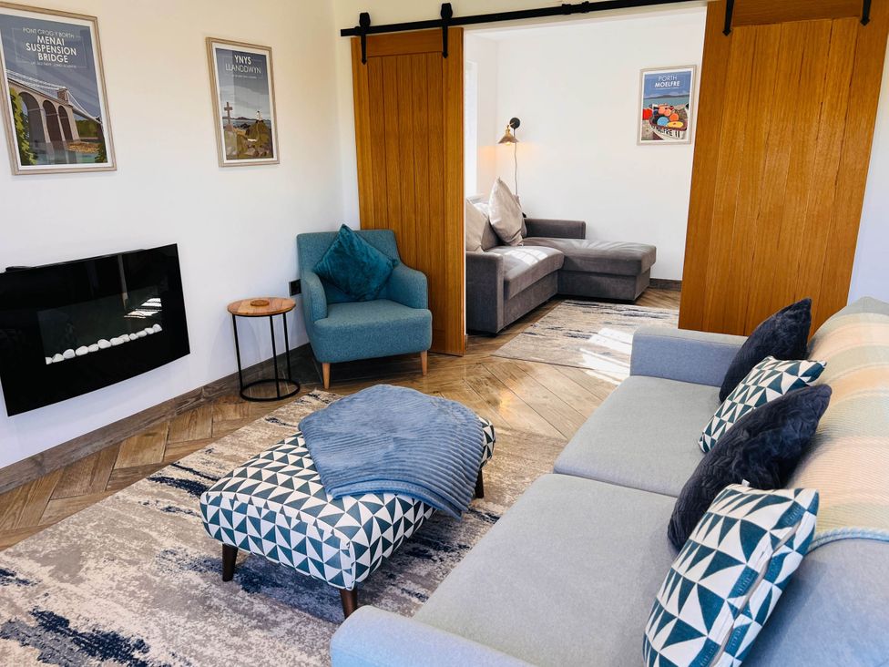A living room with a sofa and an ottoman at the property in 