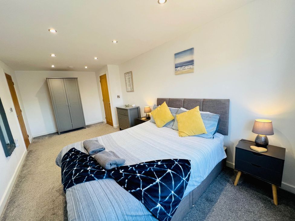 A bedroom with a bed and wardrobe at The Old Barn in Manchester