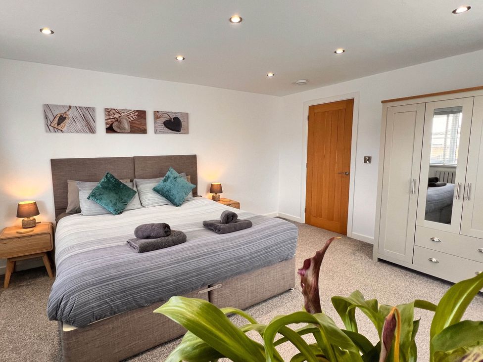 A bedroom with a double bed and wardrobe at The Old Barn in Manchester
