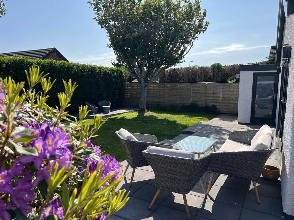 A garden with outdoor seating and a tree at the property located in the area