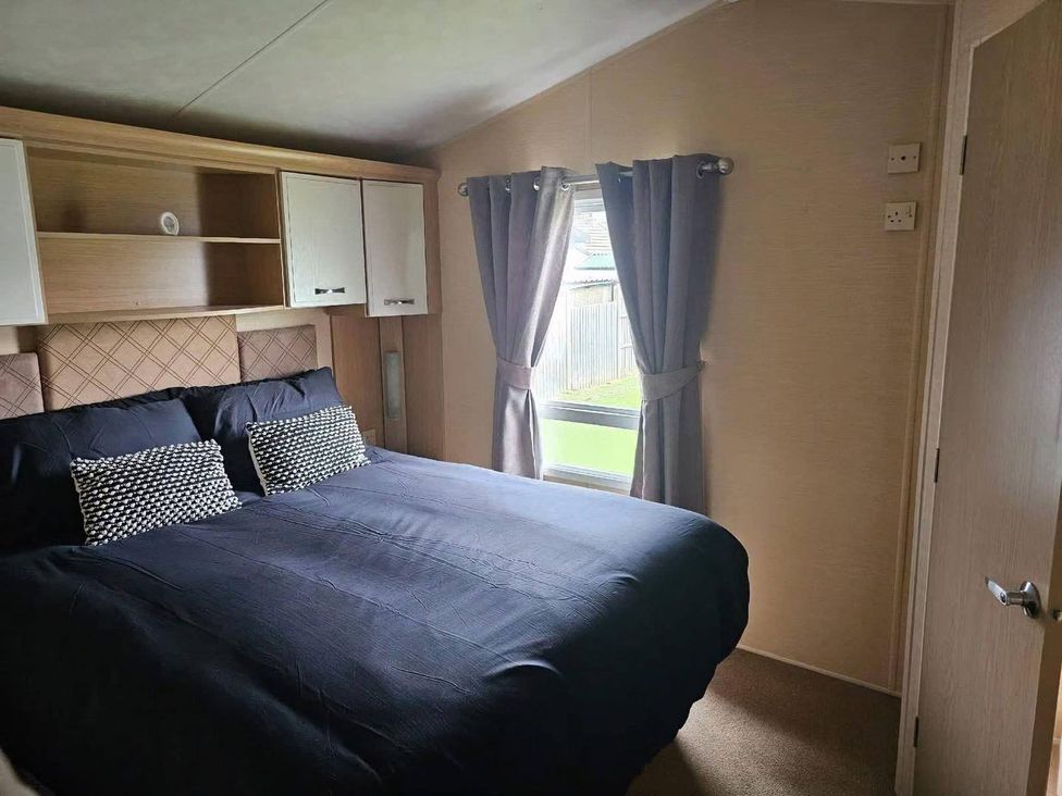 A bedroom with a bed and shelves at the property in an unknown location