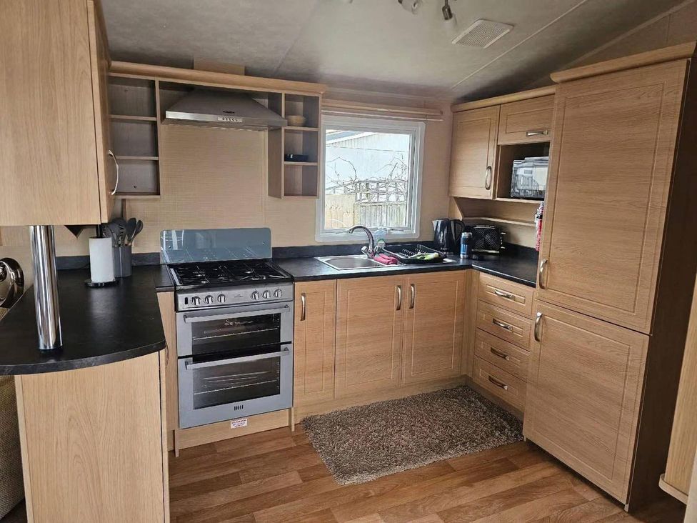 A kitchen with cabinets and appliances at The Old Barn in Manchester