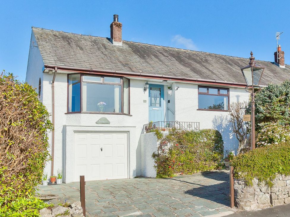 A house with a garage and garden at Lothlorien in Grange over Sands