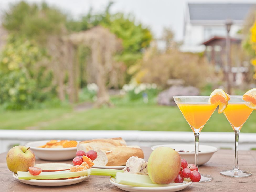 Food and drinks on a table in an outdoor setting at Lothlorien in Grange over Sands