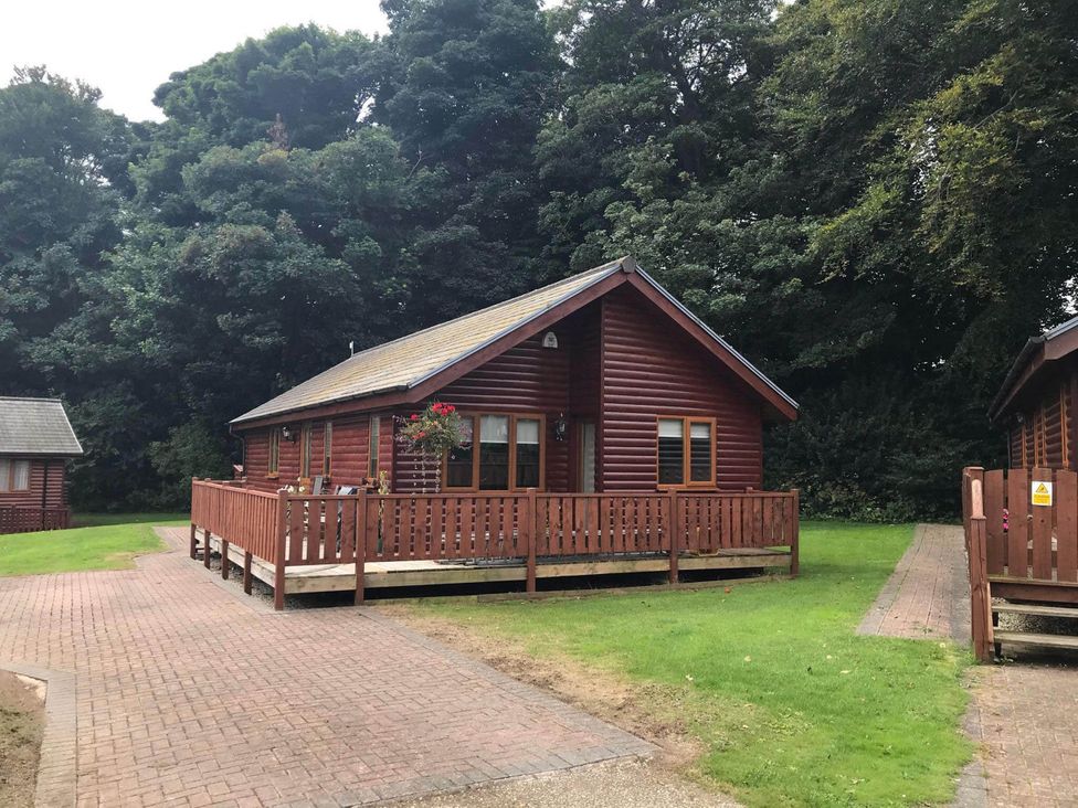 A wooden lodge with a deck area at Stunning 2 Bedroom Pet Friendly Lodge in Bridlington