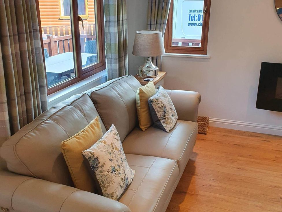 A living room with a sofa and lamp at Stunning 2 Bedroom Pet Friendly Lodge in Bridlington