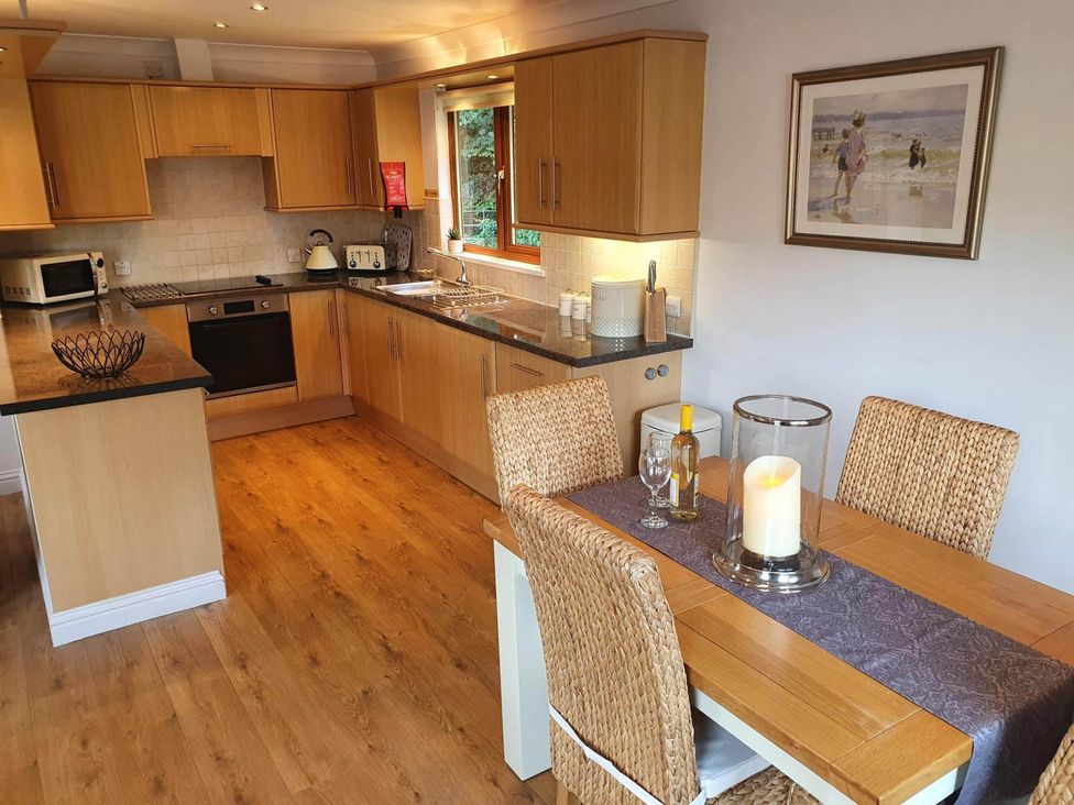 A kitchen with a dining table and chairs at Stunning 2 Bedroom Pet Friendly Lodge in Bridlington