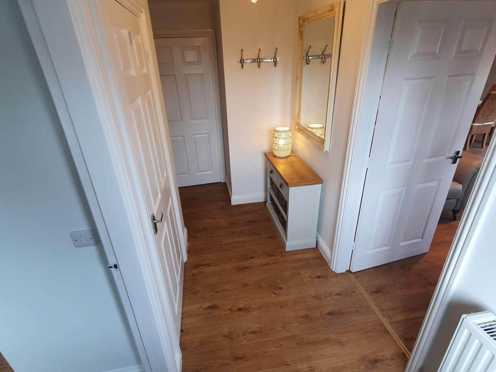 A hallway with a sideboard and a mirror at Stunning 2 Bedroom Pet Friendly Lodge in Bridlington