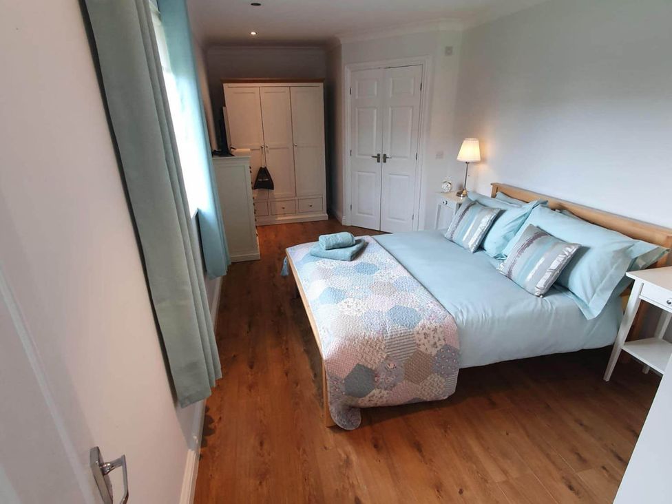 A bedroom with a bed and wardrobe at Stunning 2 Bedroom Pet Friendly Lodge Bridlington