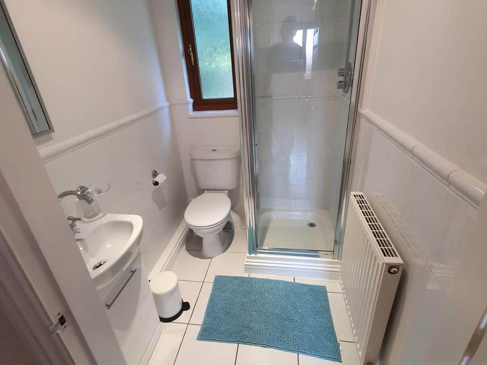 A bathroom with a toilet, sink, and shower at Stunning 2 Bedroom Pet Friendly Lodge in Bridlington
