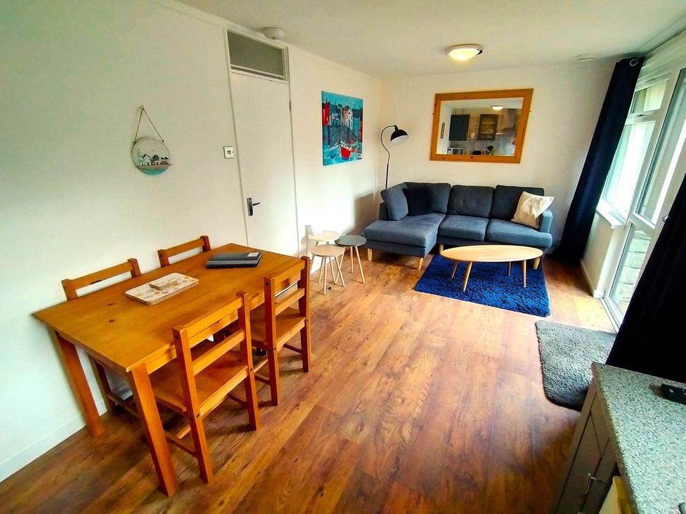 A living room with a table and chairs at Painters Cottage 2Bed Chalet Free Leisure Passes near St Ives