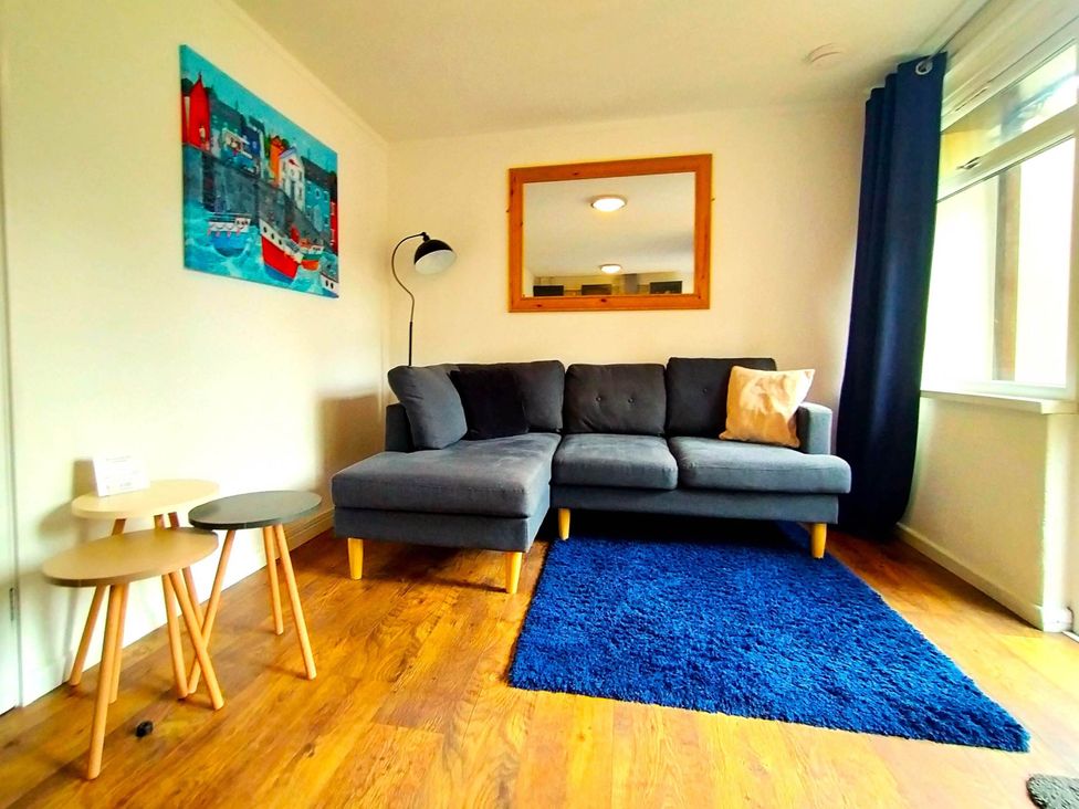 A living room with a sofa and tables at Painters Cottage 2Bed Chalet Free Leisure Passes Near St Ives