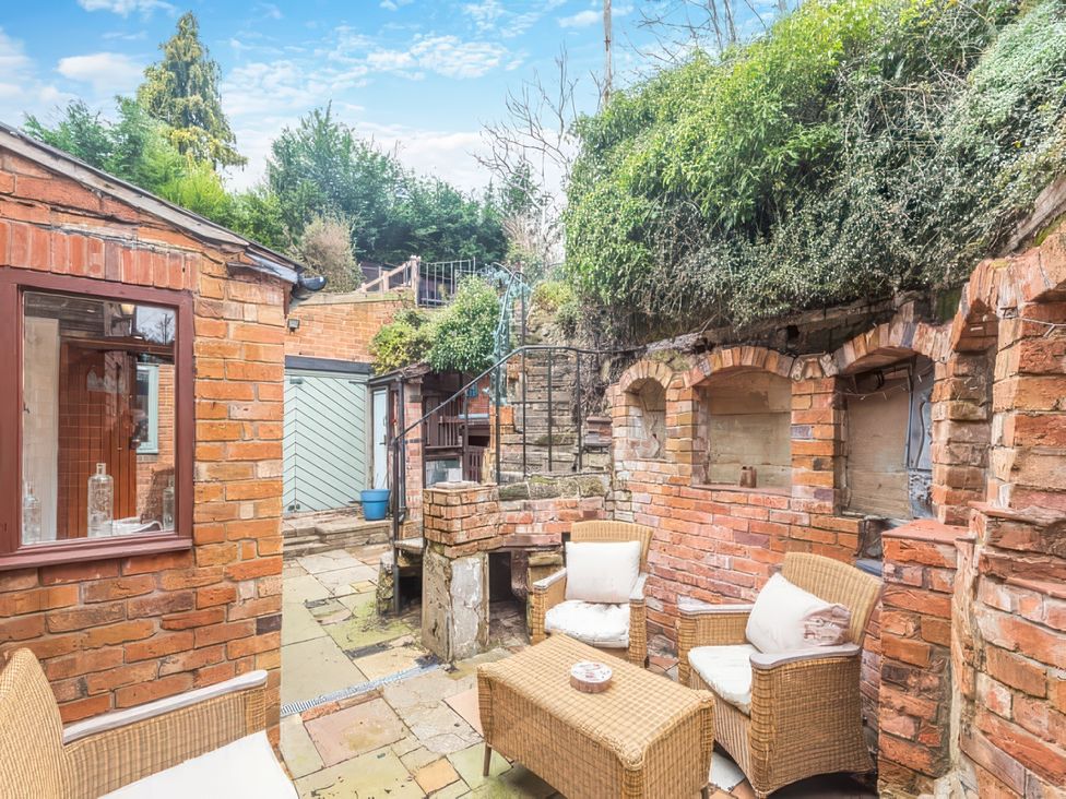An outdoor seating area with brick walls and plants at 