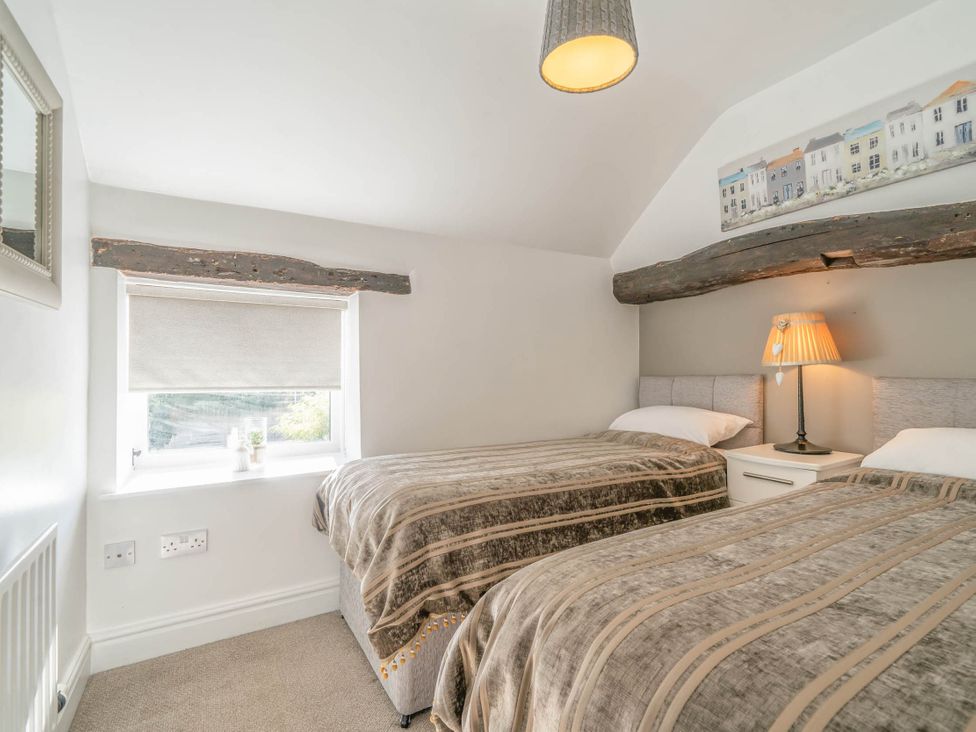 A bedroom with two beds and a window at Cosy cottage near scenic walks and country pub, Penrith