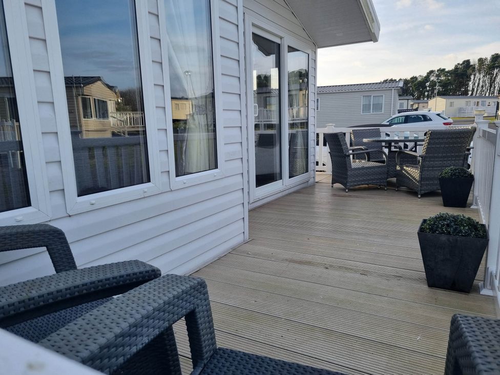 An outdoor space with chairs and a table at Cayton Bay Lodge Parkdean Resorts Scarborough
