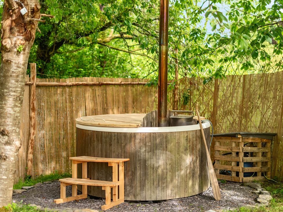 A hot tub in an outdoor area at Sleeps 2 - Private Hot Tub - Fire Pit, St. Dogmaels near Cardigan