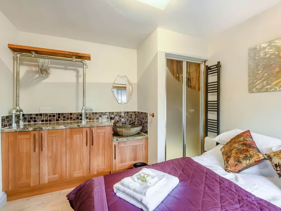 A bedroom with a bed and a sink at Luxury 2 bedroom Lodge in rural lincolnshire Kirton