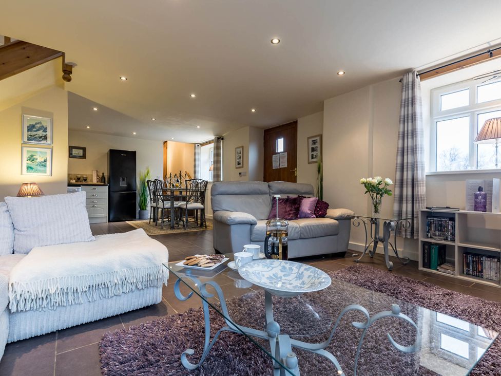A living room with a sofa and coffee table at The Old Barn in Manchester