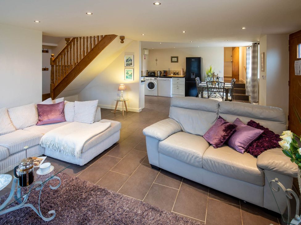 A living room with a sofa and coffee table at the property in an unknown location