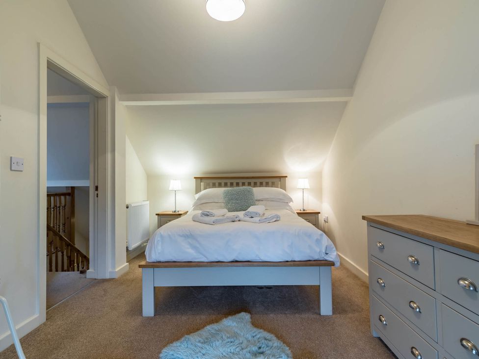 A bedroom with a bed and nightstands at 