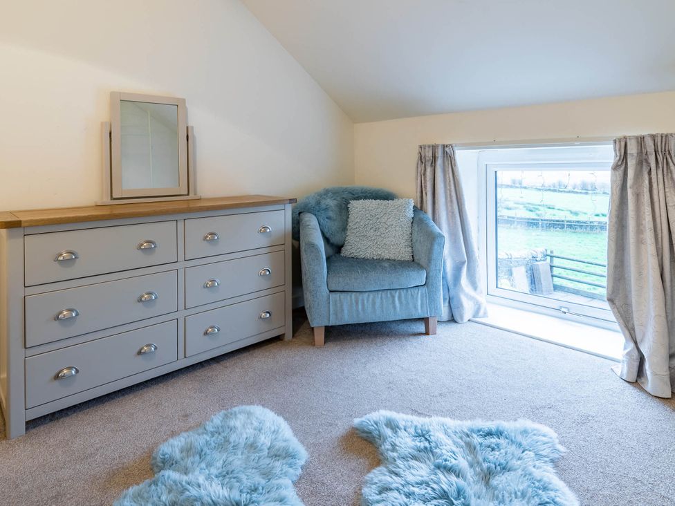 A snug with a dresser and armchair at the property in an undetermined location
