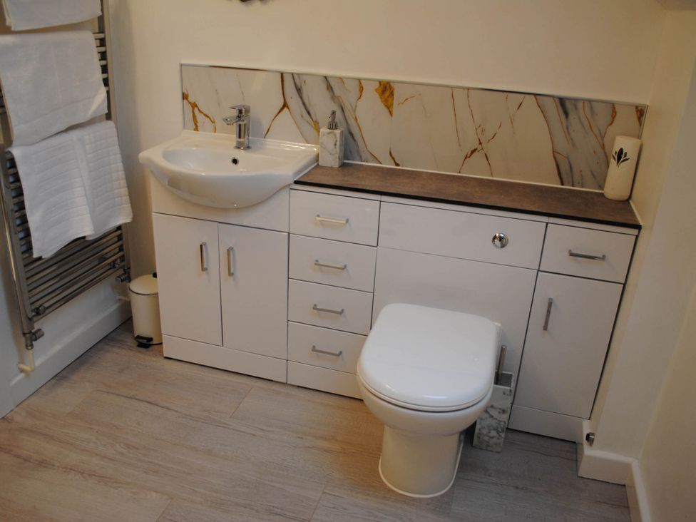 A bathroom with a sink, toilet, and towel rack at the property